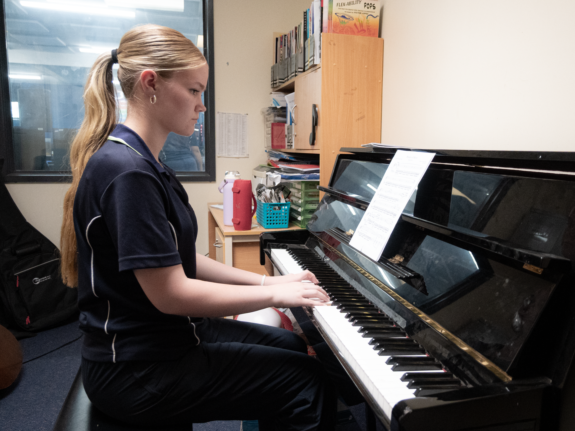 Student playing the piano in an Instrumental Music lesson