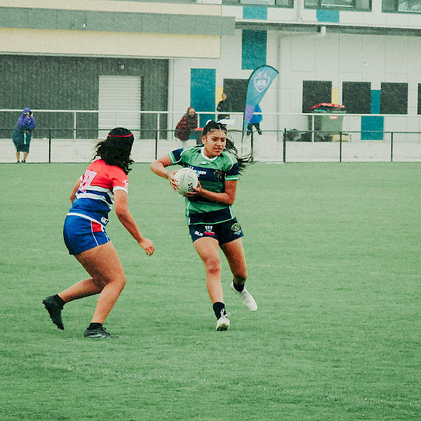 Fountain Gate Secondary College rugby player running with the ball during a girls' rugby match